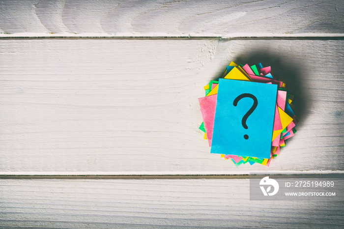 Just a lot of question marks on colored papers. vintage background