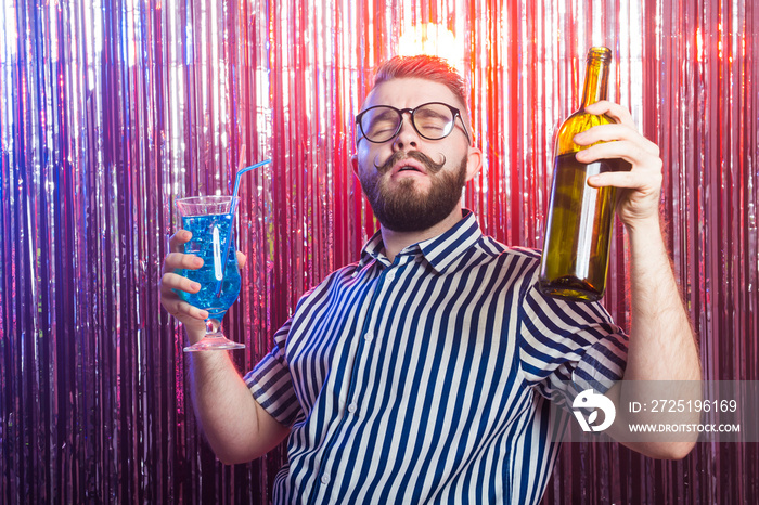 Alcoholism, fun and fool concept - Drunk crazy guy at party in a nightclub.