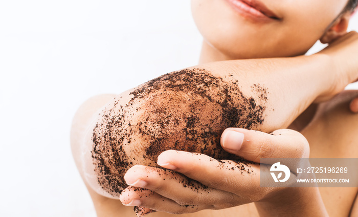 Woman is scrubbing body with coffee.