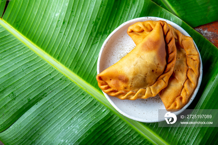 Easter Island Tuna empanadas on banana palm tree leaves. Top view