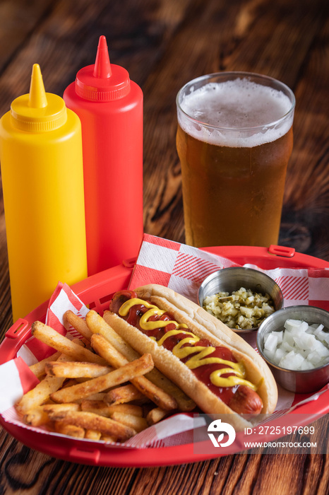 hot dog in basket with draft beer