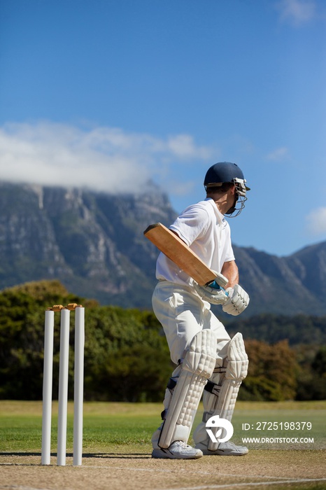 Cricket player practicing against blue sky