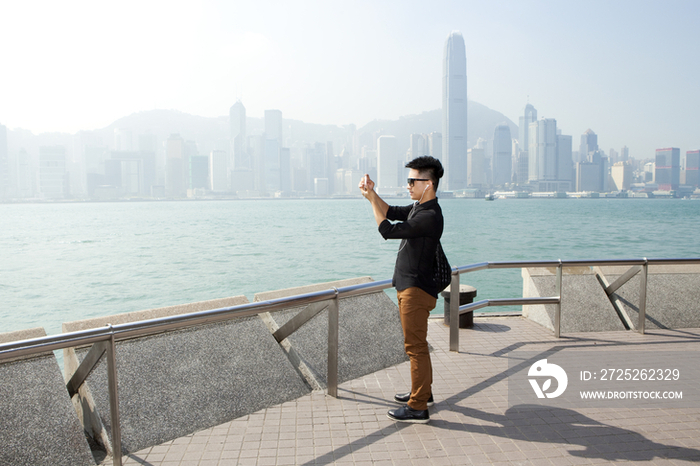 年轻男子在香港用手机拍照