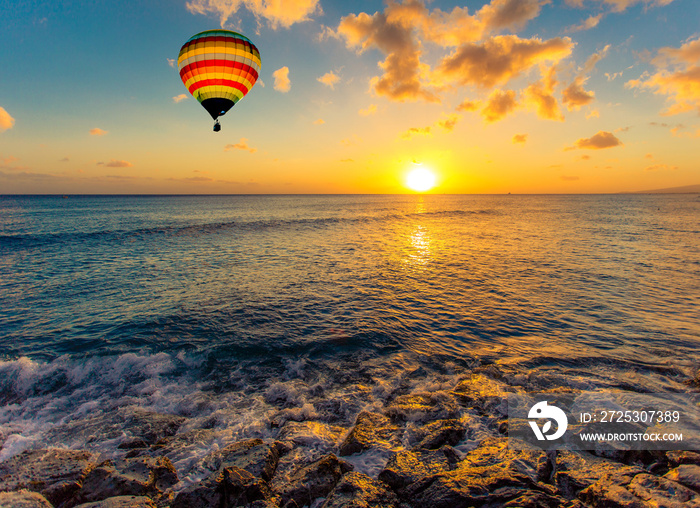 Hot air balloon over the sea at sunset