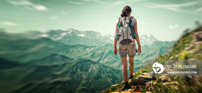 女子在山脉徒步旅行的后视图