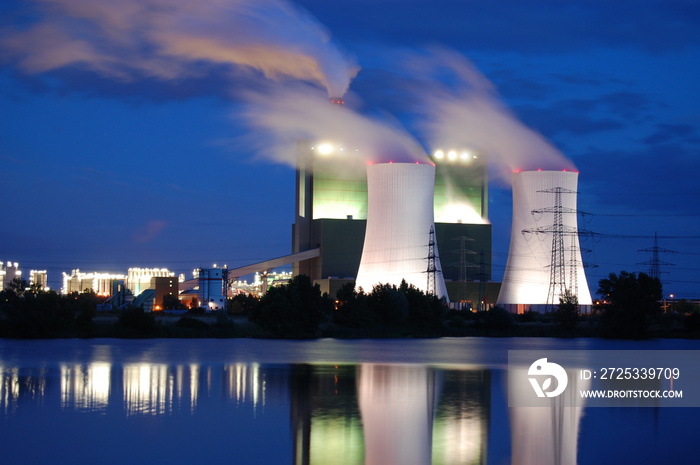 a smoking industrial power plant at night