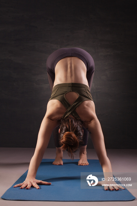 Mature woman practicing yoga on the floor