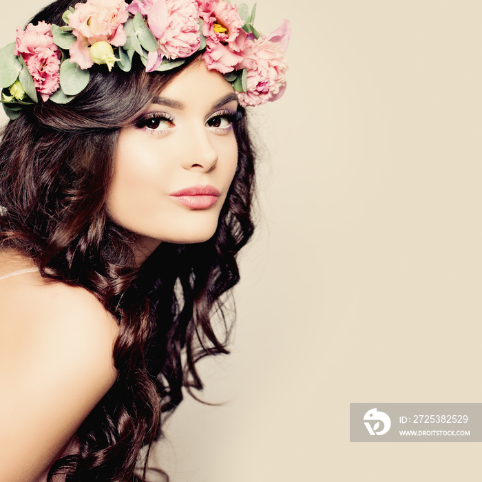 Beautiful Young Woman with Summer Pink Flowers. Long Permed Curl