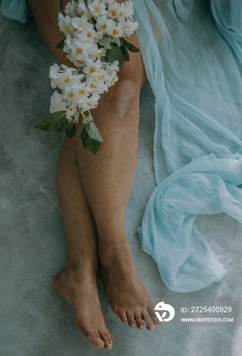 close up of white blossoms on East Indian womans legs