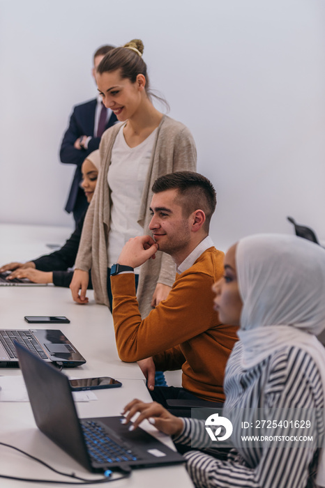 Young business colleagues working together on a computer in a comfortable office atmosphere.