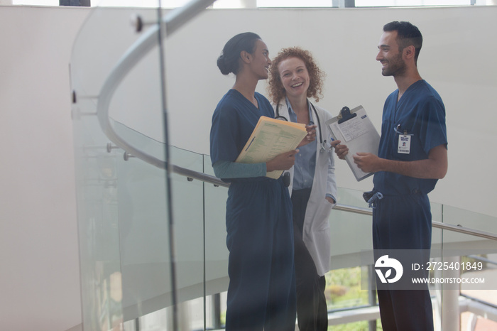 Doctor and nurses talking on hospital staircase