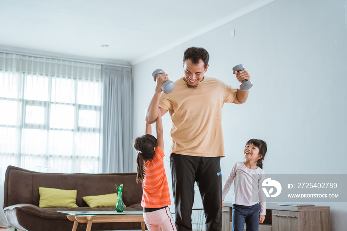 happy father and kid doing exercise together. portrait of healthy family workout at home. kid distur