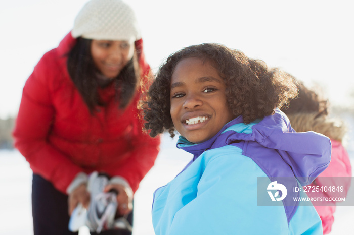 Portrait of happy little girl smiling outdoors in winter