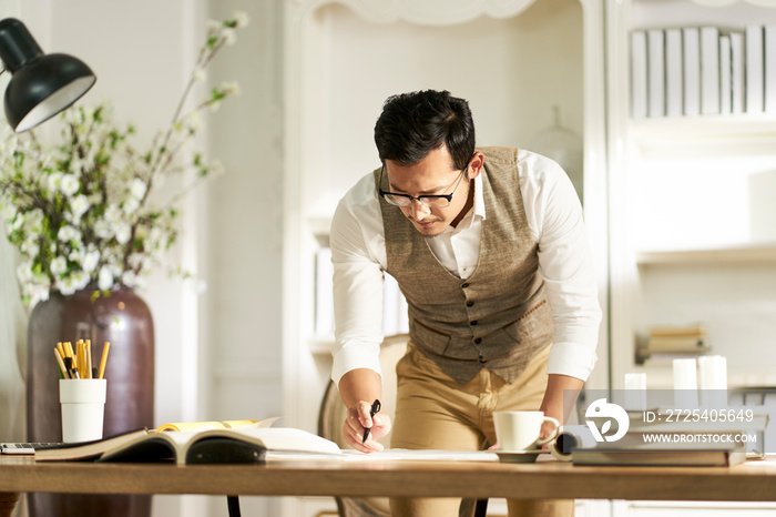 young asian designer working at home