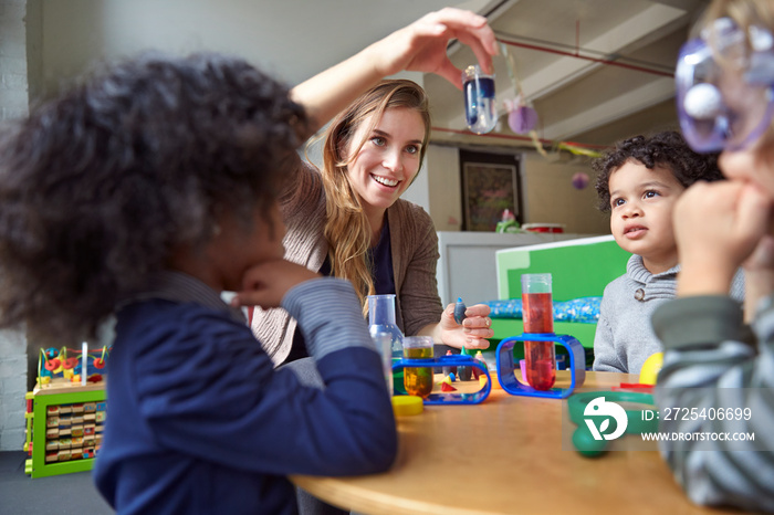 Children (2-3, 4-5) playing with toys