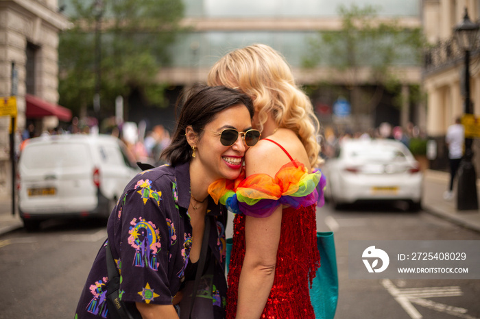 Two affectionate women in street