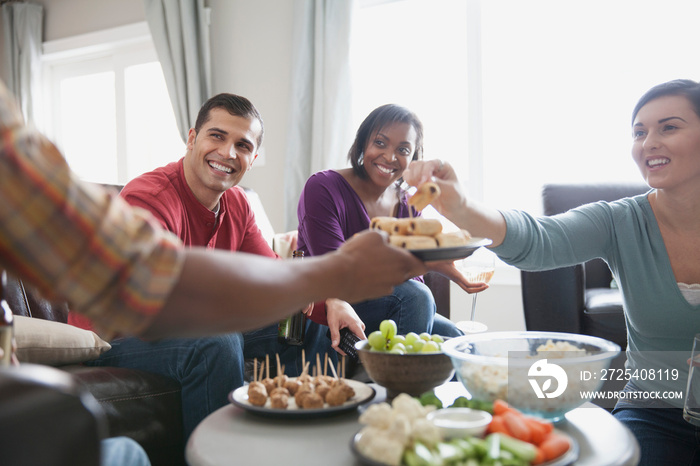 Friends celebrating with snacks at house party