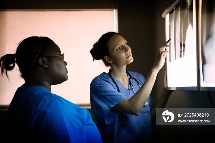 Doctors looking at x ray lightbox