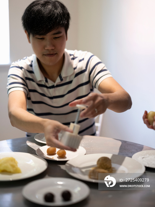 Man making moon cakes at home