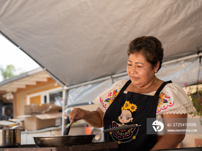 Horizontal frame of an Indigenous woman preparing Indigenous foods