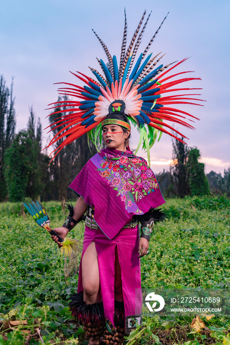 Aztec dancer in the field also known as  Chinampa  in Xochimilco, Mexico, with the traditional Aztec