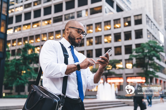 Serious ethnic worker browsing social media