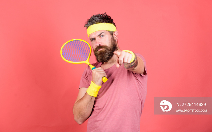 Athlete hipster hold tennis racket in hand red background. Tennis sport and entertainment. Man beard