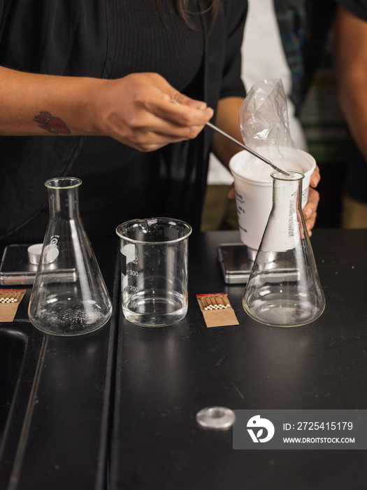 Teacher helping her students perform a lab