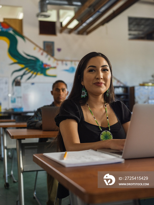 Native girl smiling while in class on her computer