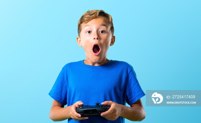 Kid playing the console on blue background