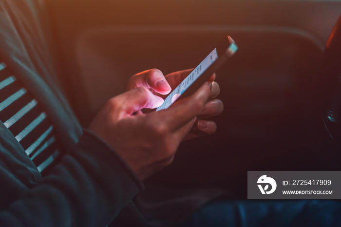 Woman texting on mobile phone in car at night