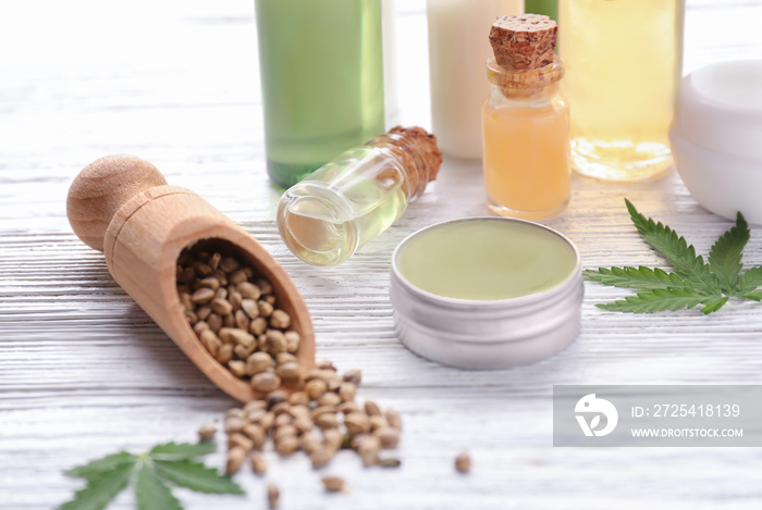 Beautiful composition with jar of hemp lotion on wooden background