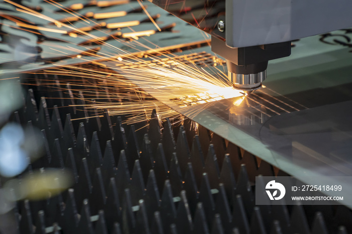 CNC激光切割机用火花光切割金属板的特写。现代sh