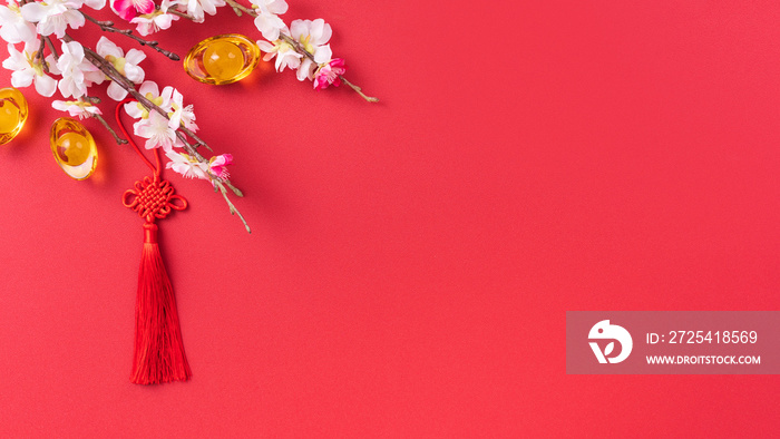 Design concept of Chinese lunar new year - Beautiful Chinese knot with plum blossom isolated on red 