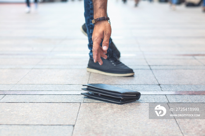 man hand wallet in street floor background