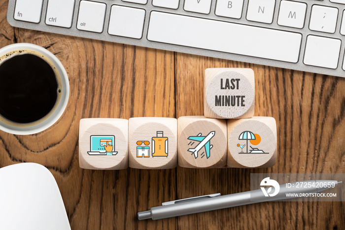 Last minute online travel specials concept with a row of wooden blocks with icons depicting laptop, 