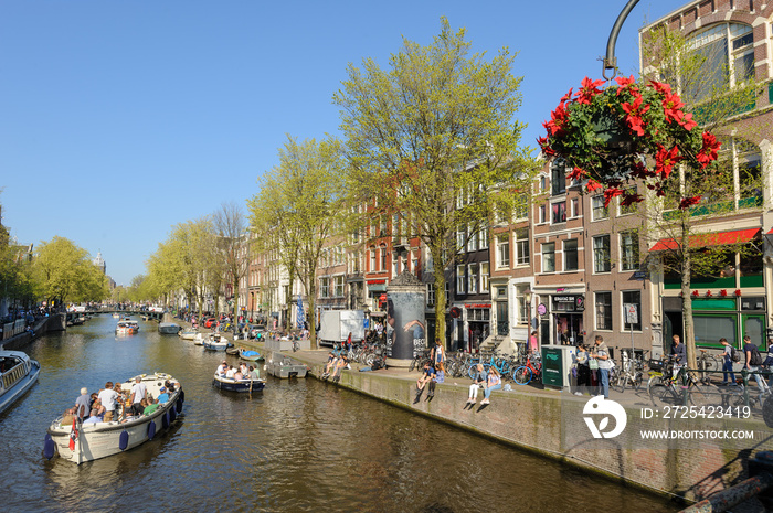 People in canal area of Amsterdam during spring time