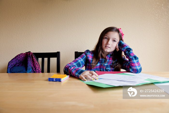 Portrait of girl doing homework at home