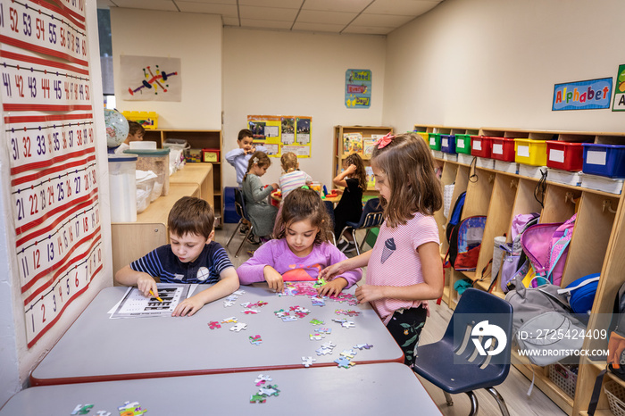 Children doing classwork and putting puzzles together