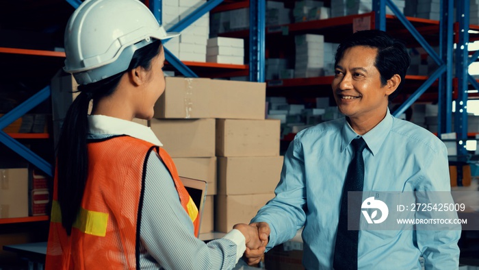 Warehouse manager and worker working in the storehouse . Logistics , supply chain and warehouse busi