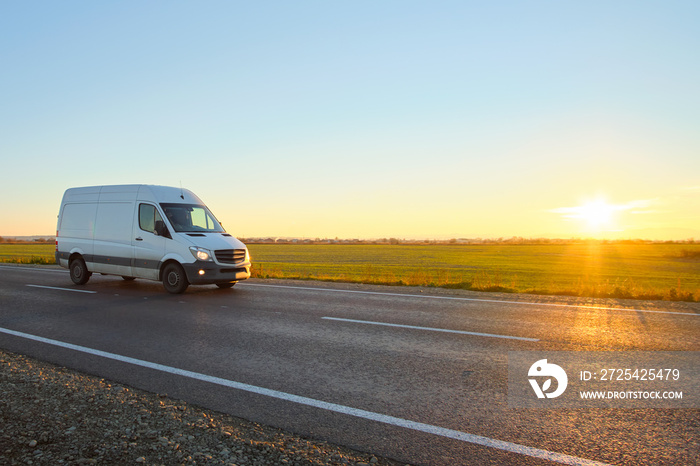 Small cargo van driving on highway hauling goods. Delivery transportation and logistics concept