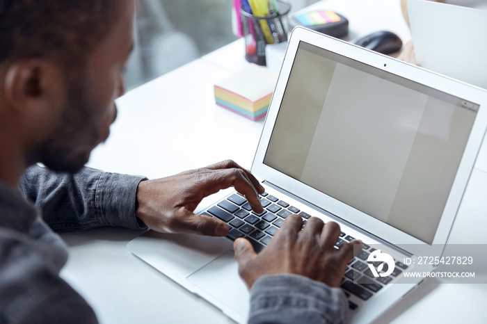 Black businessman working on laptop at office