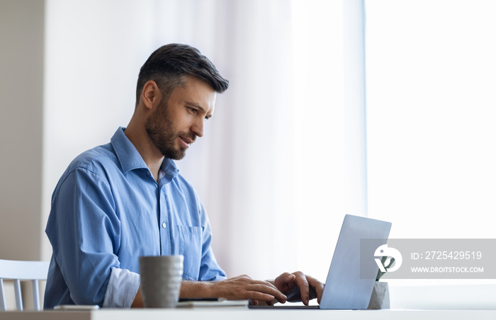 Busy Male Entrepreneur Working With Laptop Computer In Modern Office