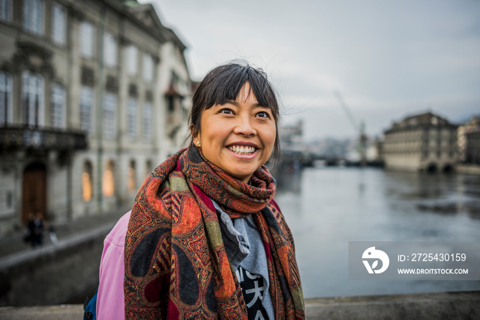 Portrait of mid adult woman in front of river, looking away