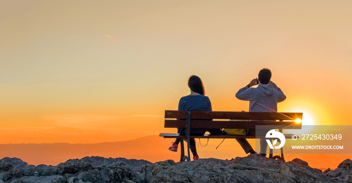 Romantic scene of couple watching sunrise.