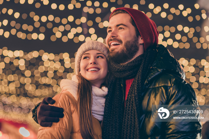 Photo of affectionate boyfriend hug girlfriend look enjoy x-mas tradition illumination evening outsi