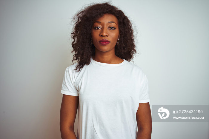 Young african american woman wearing t-shirt standing over isolated white background Relaxed with se