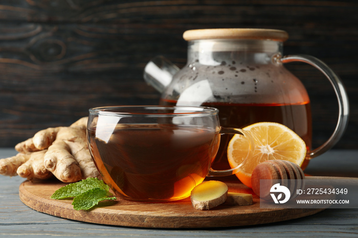 Concept of breakfast with ginger tea on wooden background