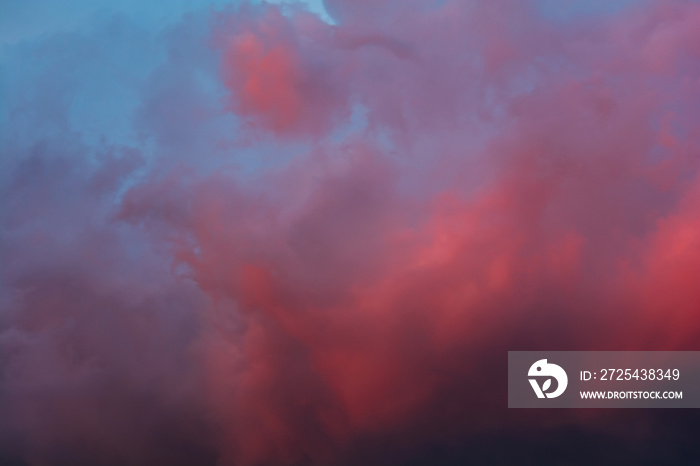 Dramatic sky with bright red and dark blue stormy clouds. Nature background