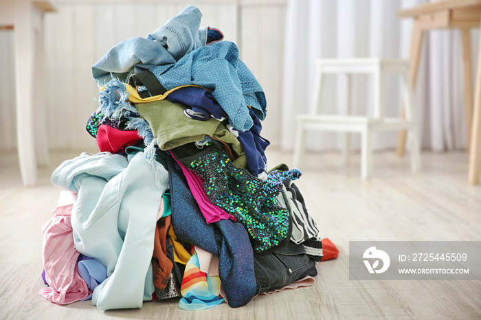 Pile of colorful clothes on floor indoors